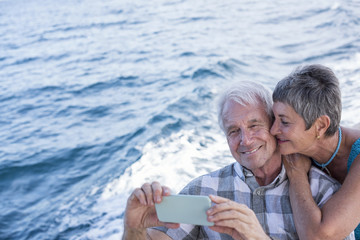 Happy couple on a boat trip taking a selfie