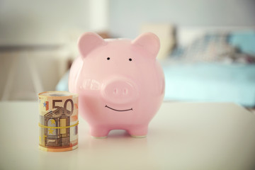 Savings concept. Piggy bank and money on table