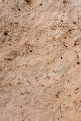 Background quarried rough textured limestone rock