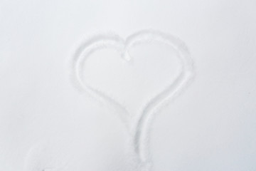 heart shape silhouette or print on snow surface