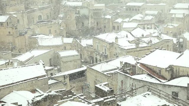 landscape of Matera, Italy with snow covered roofs of the city