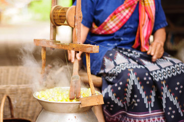 Boiling cocoon silkworm in the pot to make silk yarn