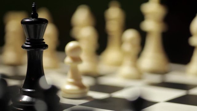 Panoramic shot of a chess board, with white pawn conquering the black king.