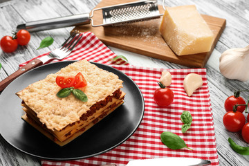 Homemade meat lasagna on white wooden table