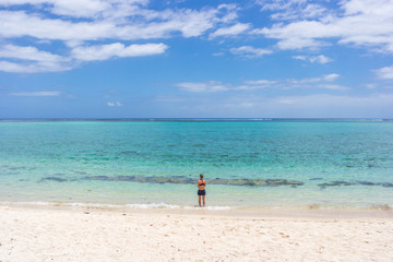 Fototapeta premium Woman is going to swim on beautiful beach in Mauritius