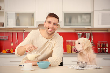 Man and  dog enjoying breakfast at the kitchen
