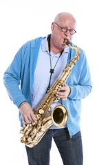 Obraz na płótnie Canvas middle aged man plays the tenor saxophone against white studio b