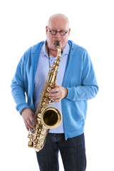 middle aged man plays the tenor saxophone against white studio b