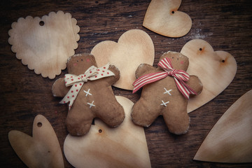Fototapeta premium Gingerbread man and heart on a dark background. Free space for text. Studio shooting. Subject shooting.