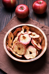 Fototapeta premium Dehydrated apples chips in wooden bowl