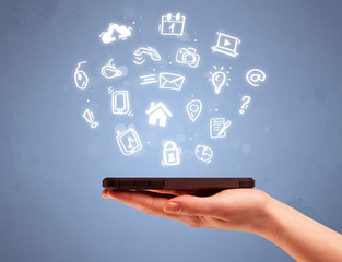 Hand holding tablet phone with drawn icons