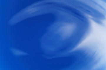 abstract waves on blue colored liquid from above, background