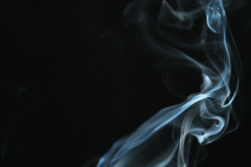 Obraz premium real blue smoke over black background, abstract backdrop