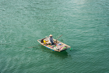 Vietnamese saleswoman from boat in Halong bay, Vietnam
