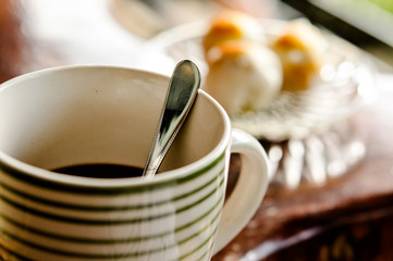 Cup of coffee and moon cake on a wooden table
