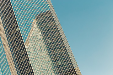 Obraz premium Skyscrapers with glass facade. Modern buildings in Paris business district. Concepts of economics, financial, future. Copy space for text. Dynamic composition. Toned