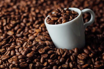 Two bronze cup full of coffee on the grains pile. Italian traditional morning short drink on breakfast. Close-up. Toned