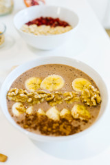 Breakfast with milk and oat, nuts, almonds, banana and pomegranate.
