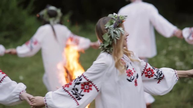 Midsummer. Young people in Slavic clothes revolve around a fire in the Midsummer. .