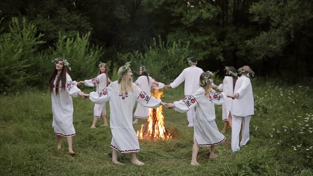 Midsummer. Young people in Slavic clothes revolve around a fire in the Midsummer. .