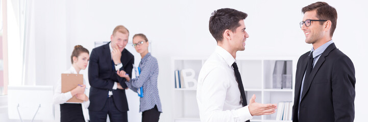 Fototapeta premium Two guys in suits talking