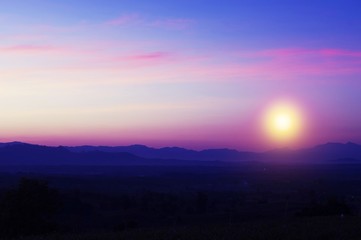 Beautiful silhouette landscape and sunset at night on a meadow on early winter at moon