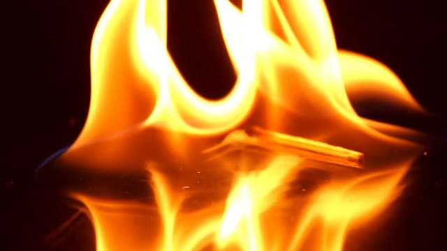 Falling matchstick lights a flammable liquid, Slow motion
