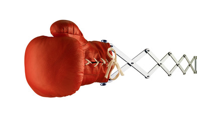 Red boxing glove isolated on scissor spring