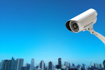 CCTV Camera security operating with buildings blur background