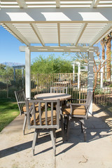 Landscaped Garden with Wooden Dining Table Set in the Shade