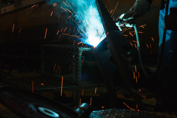 Welder of Metal Welding with sparks and smoke in  manufacture 