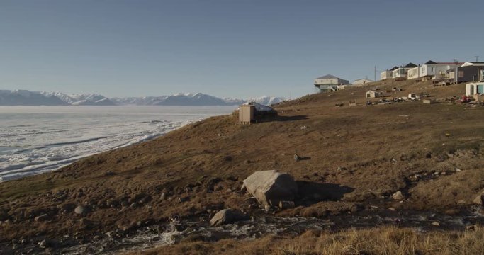 Pan Pond Inlet Houses along creek to sea ice in bay