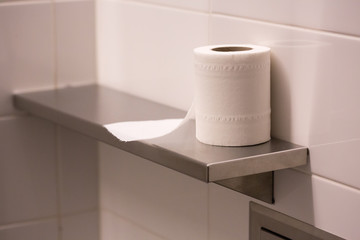 bathroom tissue on shelf