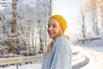 Portrait of happy young woman have fun at beautiful sunny winter