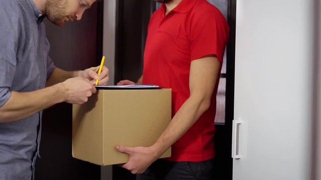 home delivery service - man signing receipt of delivery package