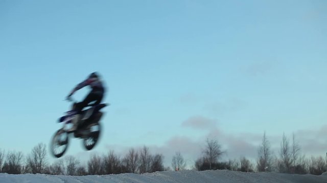 Jumping on a motorcycle motocross of winter