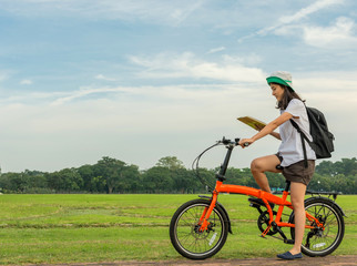 young student reading book and riding bicycle, freedom and learn