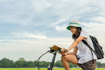 young student reading book and riding bicycle, freedom and learn