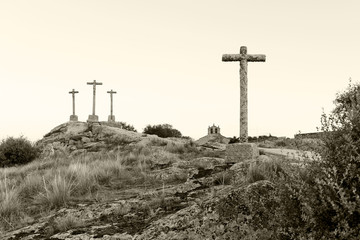 three crosses carved in the stone on fund to the evening