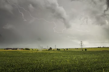 Fotobehang Lightning Storm Over The Fields And Powerlines © Adam