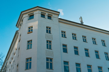 white corner house with high contrasted sky