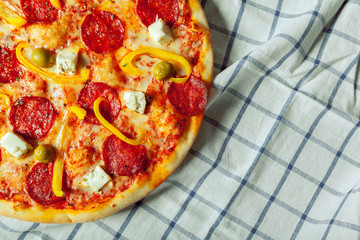 Fresh tasty pizza on wooden background