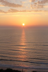 sunset on the sea with mountains