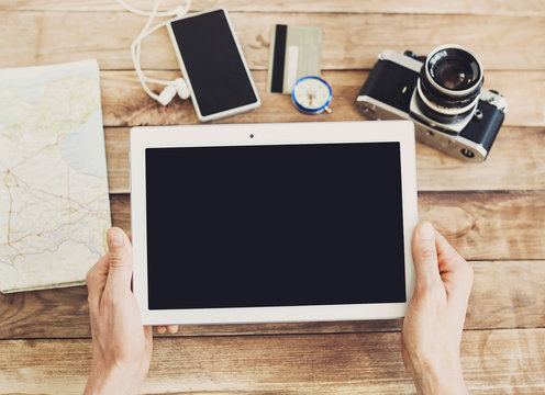 Young man planning vacation trip with digital tablet