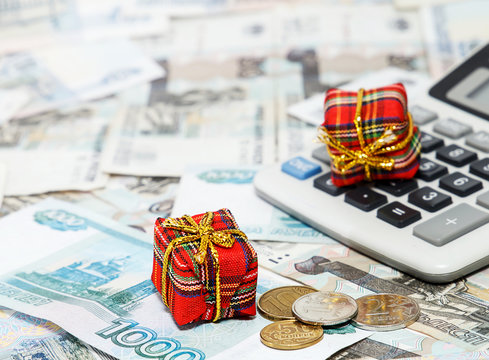 Christmas gifts on the background of Russian money and the calcu