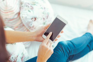 Woman with modern mobile phone in hands