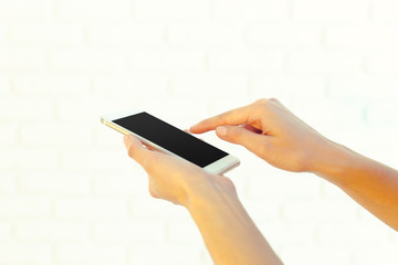 Woman with modern mobile phone in hands