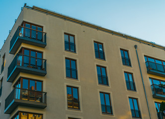 Fototapeta na wymiar orange facaded apartment building with blue windows
