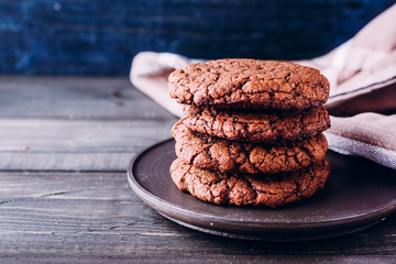 Homemade chocolate cookies on wooden table background. Food baking. Copy space