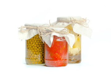 Canned vegetables in glass jars isolated on white background